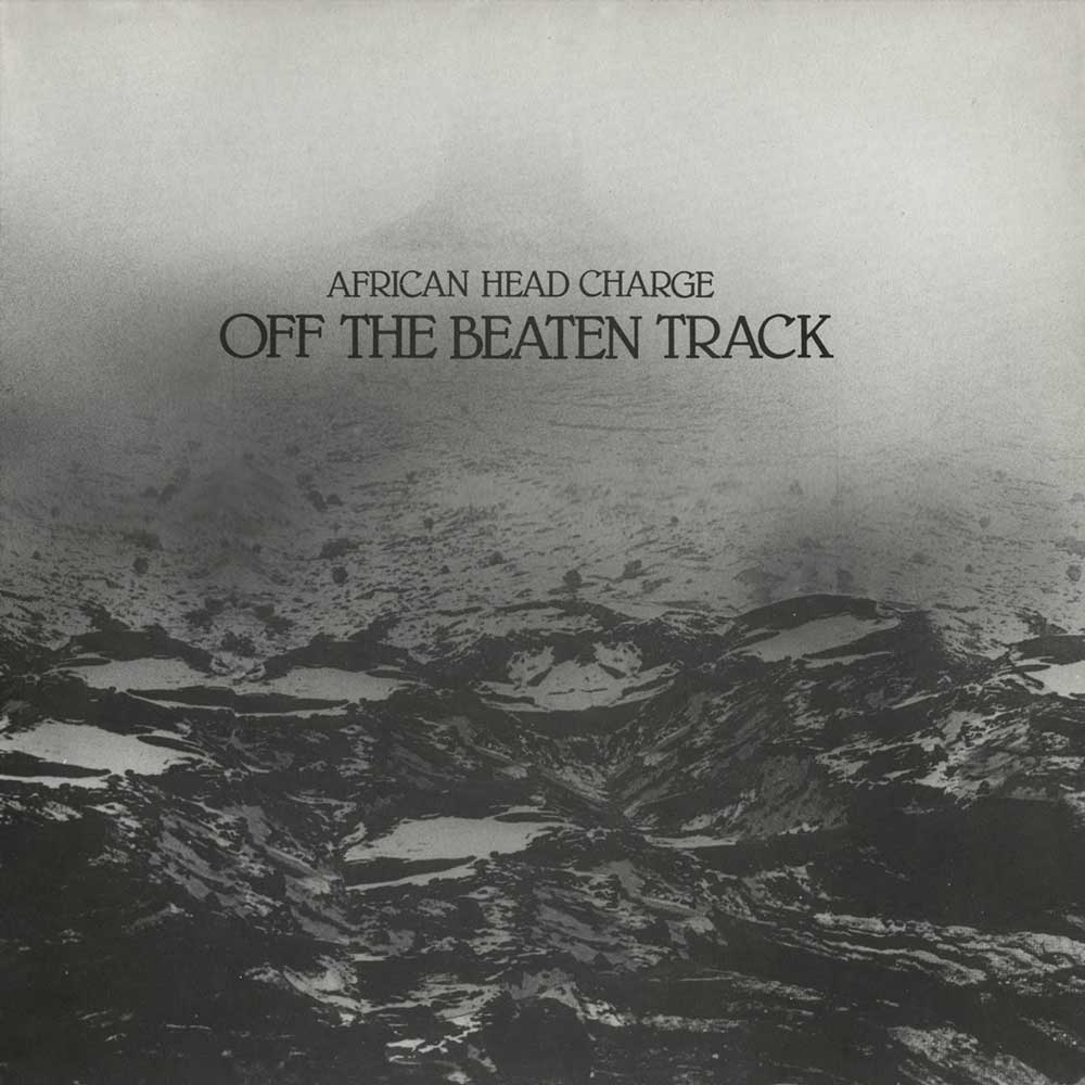 African Head Charge - Off The Beaten Track (Vinyl LP) Album cover for 'Off The Beaten Track' by African Head Charge, featuring a black and white photograph of a rugged mountain landscape with the text centered near the top.