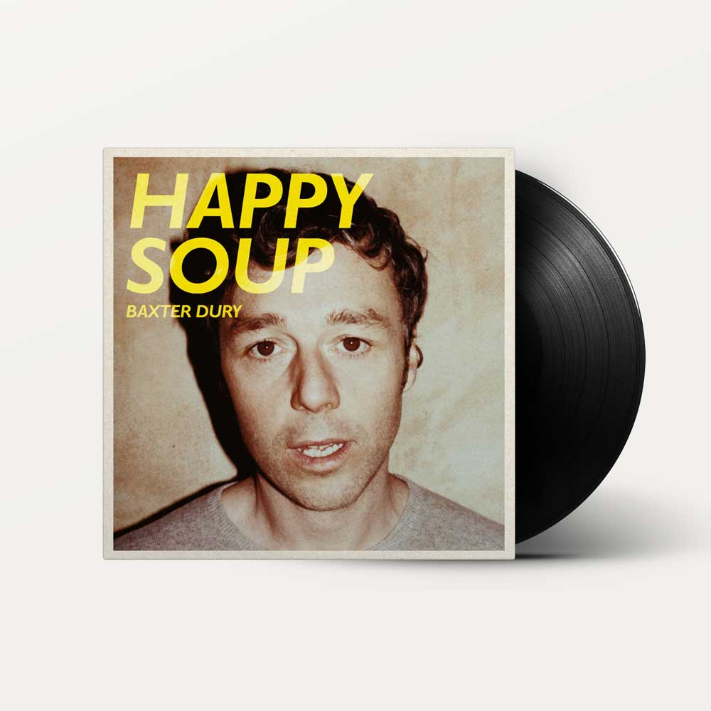 Baxter Dury - Happy Soup (Vinyl LP) Vinyl record album for Baxter Dury's 'Happy Soup' with the square album cover in front and a black vinyl record partially visible behind it on a light grey background.