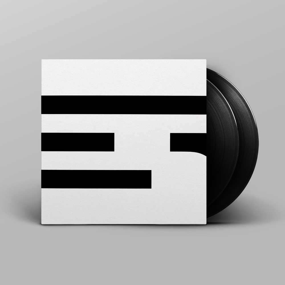 Alva Noto - Xerrox Vol. 2 (Vinyl 2 LP) A vinyl record partially pulled from a square album sleeve with the minimalist Xerrox Vol. 2 black-and-white geometric cover design, shown on a light grey background.