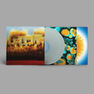Bonobo - Distance In Static (Vinyl 2LP Pastel Blue) A vinyl record partially pulled from its open sleeve, showing a translucent pale blue disc over three colorful album-art panels: a smoky landscape, an abstract teal/orange pattern, and a bright sunburst on a blue field.