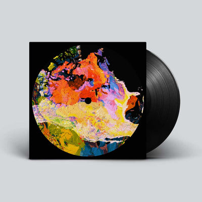 Crooked Colours - Langata (Vinyl LP) A vinyl record partially pulled from its black sleeve, featuring a colorful abstract circular artwork on the cover against a light gray background.