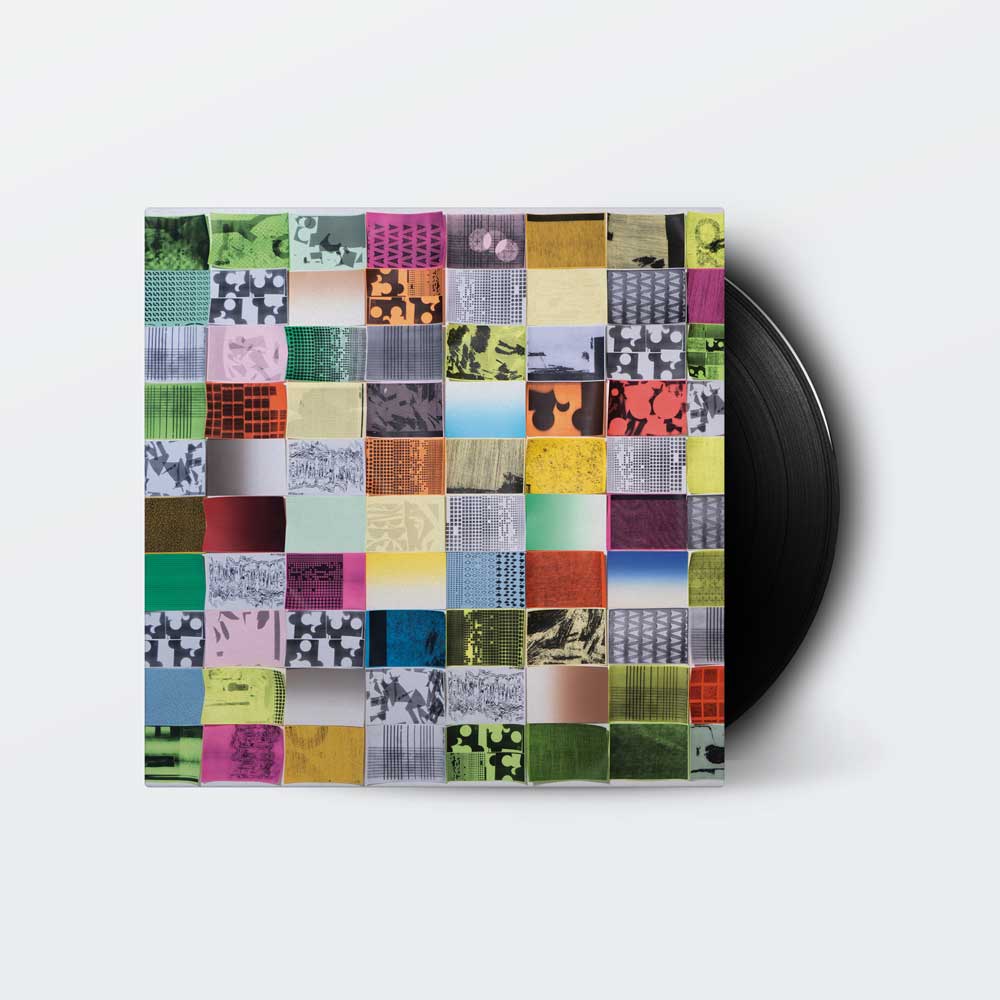 Four Tet - Three (Vinyl LP) A vinyl record partially visible behind its square album cover, which features a colorful patchwork grid of many small abstract and photographic squares in green, pink, yellow, blue, black, white, and red on a light gray background.