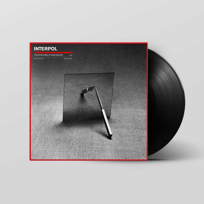 Interpol – The Other Side Of Make-Believe (Vinyl LP)A vinyl record partially pulled from its album sleeve, shown on a light gray background. The sleeve is black and white with a red border and features the text 'INTERPOL' and 'The other side of make believe'.