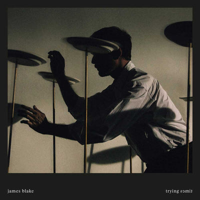 James Blake - Trying Times (Vinyl 2LP White) Album cover with a silhouette of a person interacting with shadows, featuring the artist 'James Blake' and album title 'Trying 2smile'.
