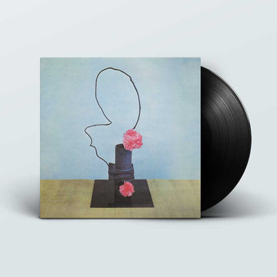 Methyl Ethel - Oh Inhuman Spectacle (Vinyl LP) A vinyl record partially pulled from its square album cover, showing surreal artwork of a black line profile silhouette with pink flowers against a pale blue background. The record itself is black and the cover is also black on the lower portion.