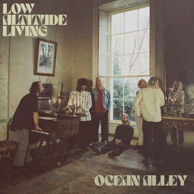 Ocean Alley - Low Altitude Living (Vinyl 2LP Clear) Album cover art for 'Low Altitude Living' by Ocean Alley, depicting a group of musicians in a dimly lit room with a large window.
