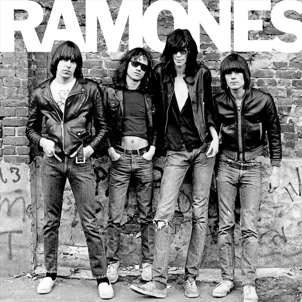 Ramones - Ramones (Vinyl LP 180g Remastered) Record cover of the Ramones in black and white photo of the band Ramones standing against a brick wall, with the band's name in large letters across the top.