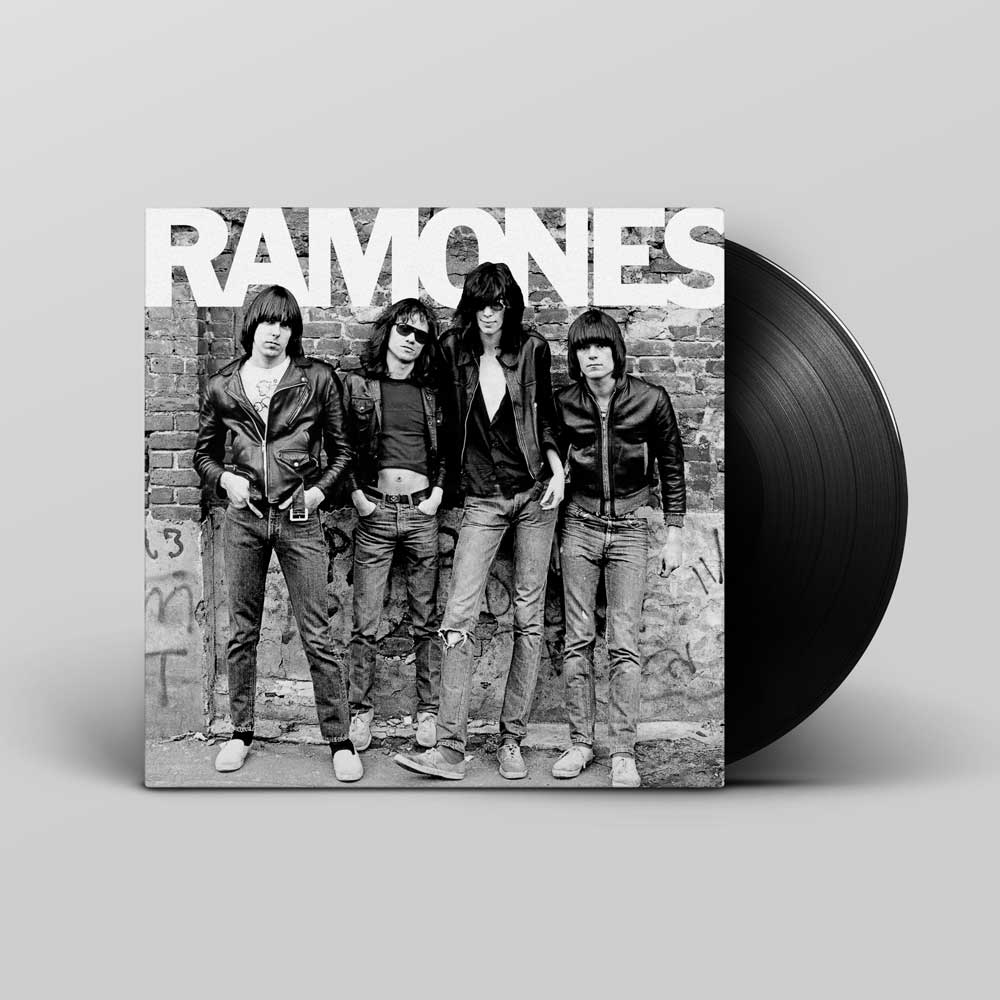 Ramones - Ramones (Vinyl LP 180g Remastered) Ramones vinyl record album with the black-and-white cover art showing the band members and a large black vinyl record partially visible behind the sleeve on a light grey background.