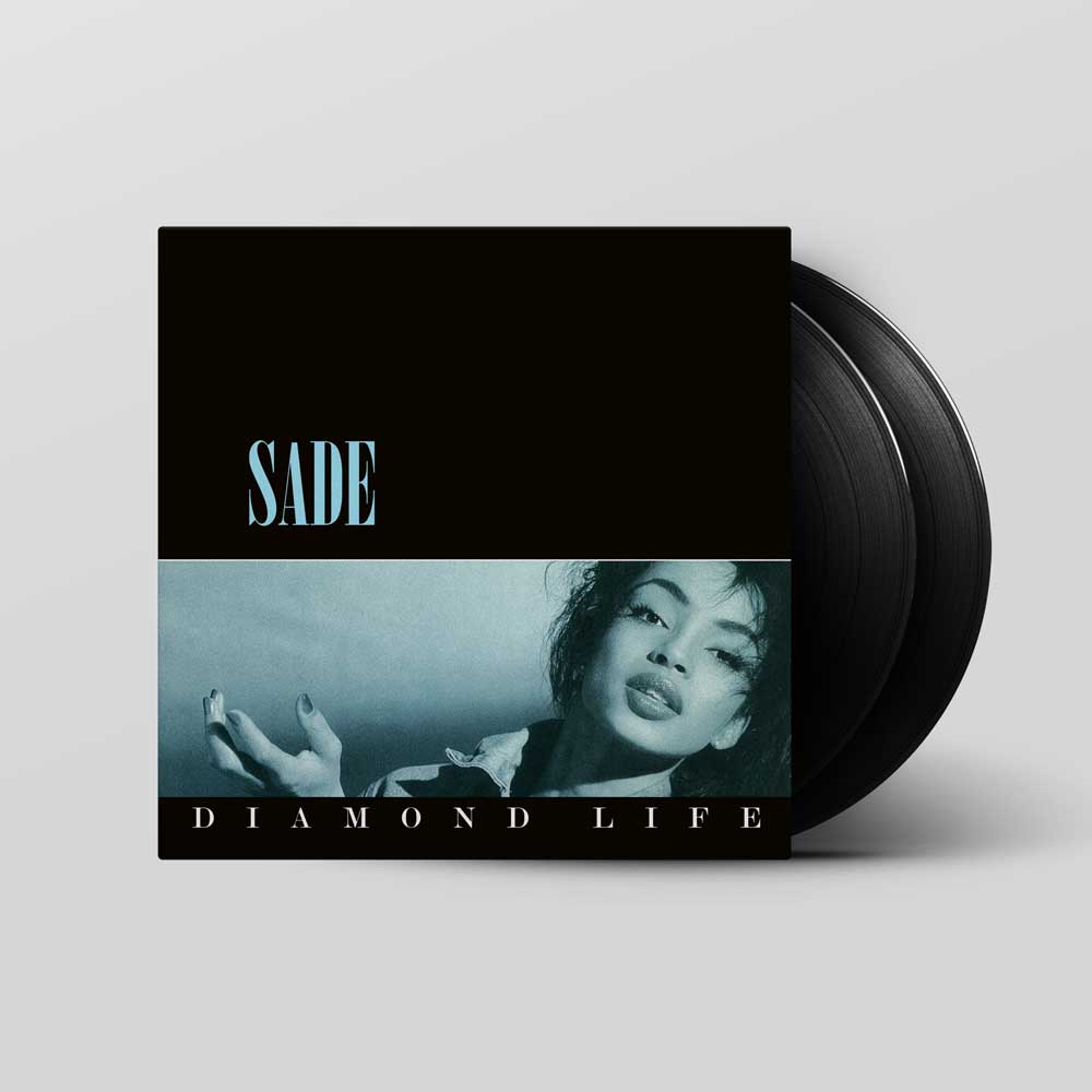 A vinyl record album for 'SADE - DIAMOND LIFE' shown with its black cover sleeve and two black vinyl records partially visible against a light gray background.