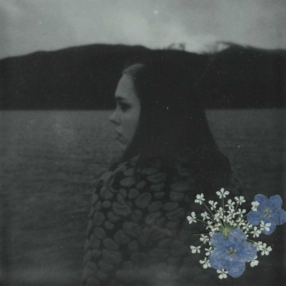Soccer Mommy - Evergreen (Vinyl LP Baby Blue) Record album cover showing a black and white portrait of a woman with a field and flowers in the foreground