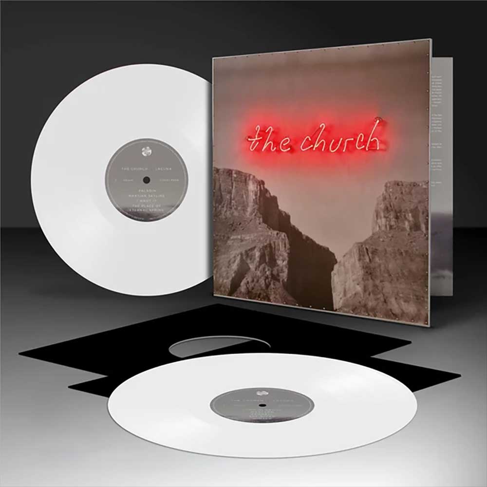 The Church - Lacuna (Vinyl 2LP White Australian Exclusive) Vinyl record album shown with a white record in front, a second white record behind it, and the album cover standing upright. The cover features a sepia canyon scene with glowing red neon-style 'the church' text.