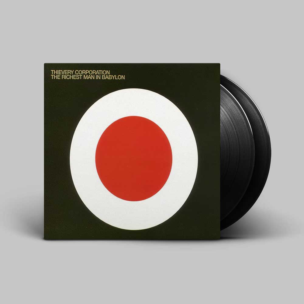 Thievery Corporation - The Richest Man In Babylon (Vinyl 2LP) A vinyl record partially pulled from its sleeve, showing the album cover artwork for 'The Rarest Man in Babylon' by The Very Corporation. The sleeve is dark olive green with a large white circle containing a red center, and the black vinyl record is visible behind it on a light gray background.